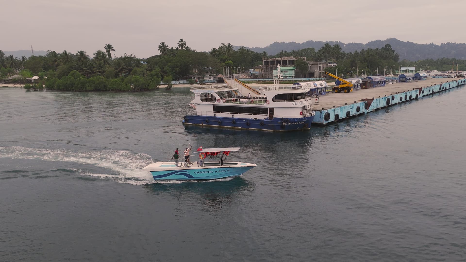 Our semi-submarine docked at the jetty with Canopus Aarya cruising past