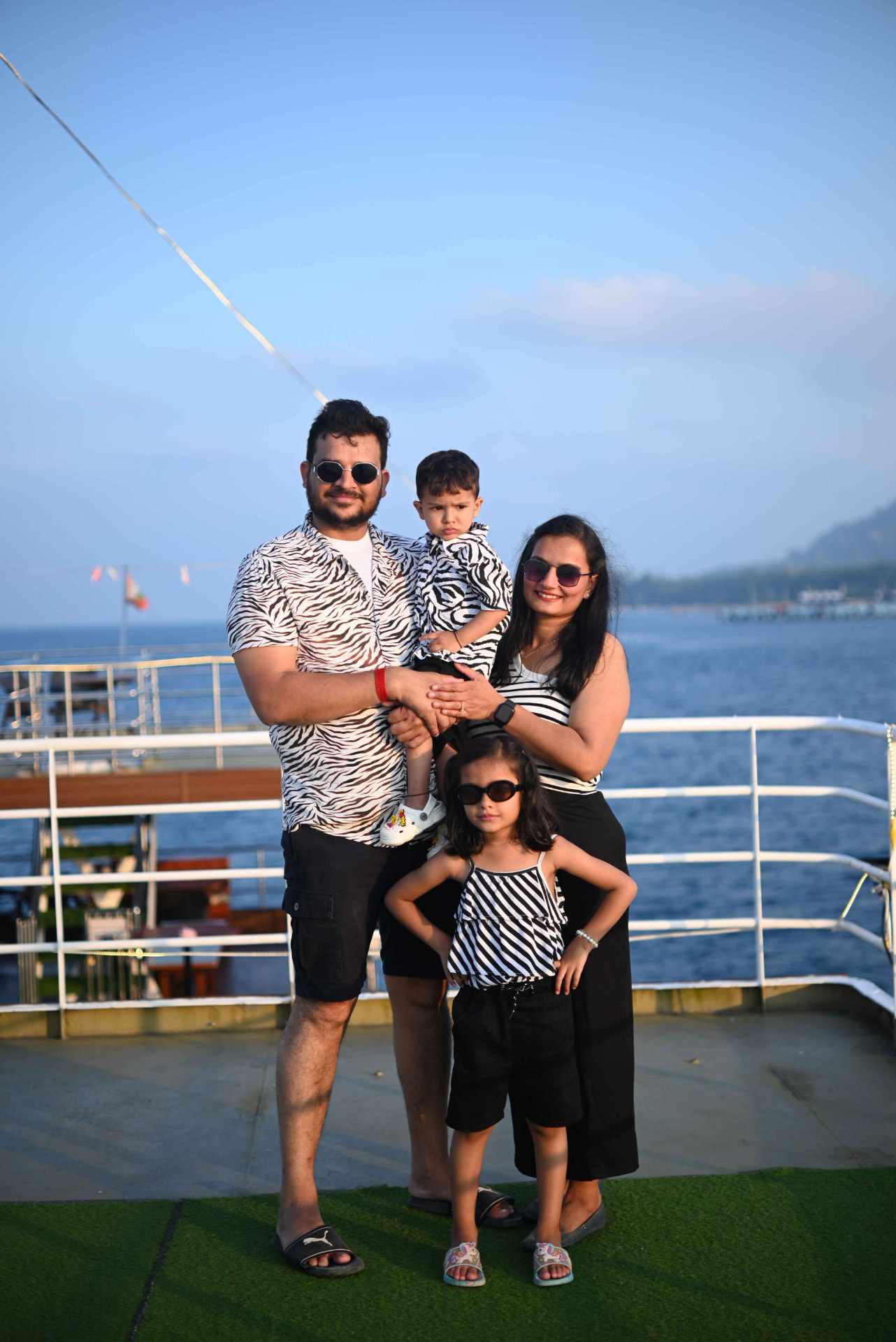 A family posing on the open deck of the sunset cruise