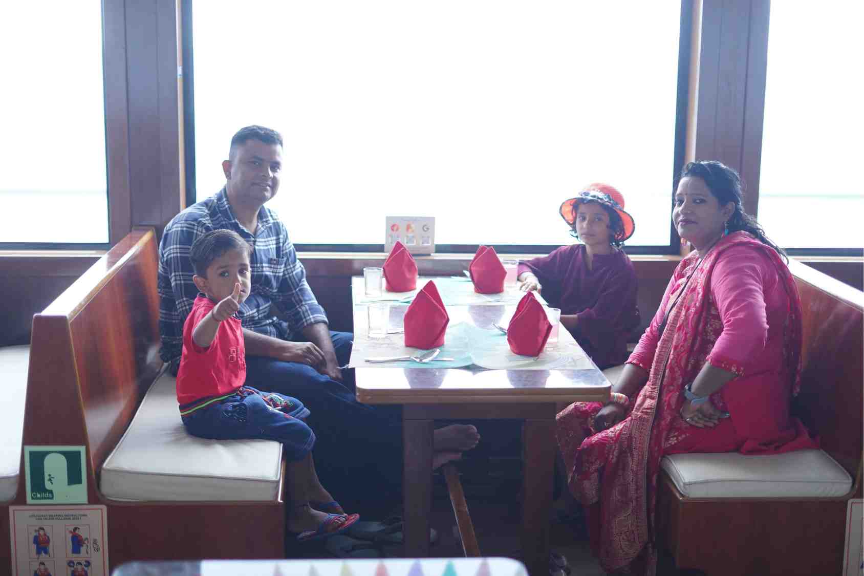 A family seated together for lunch on the cruise