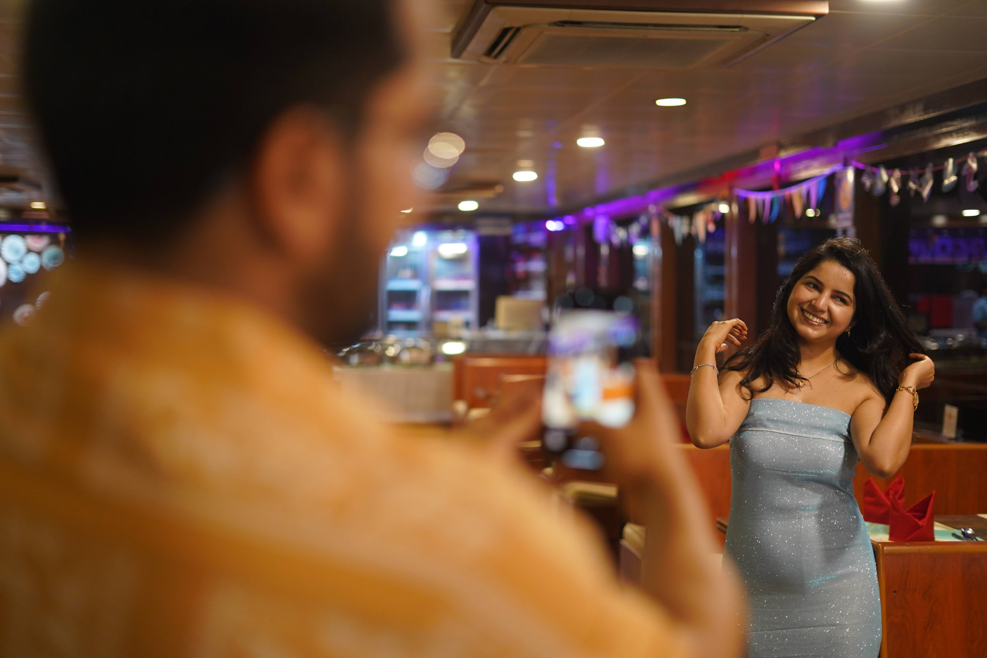 A guest smiling while being photographed on board during the dinner cruise