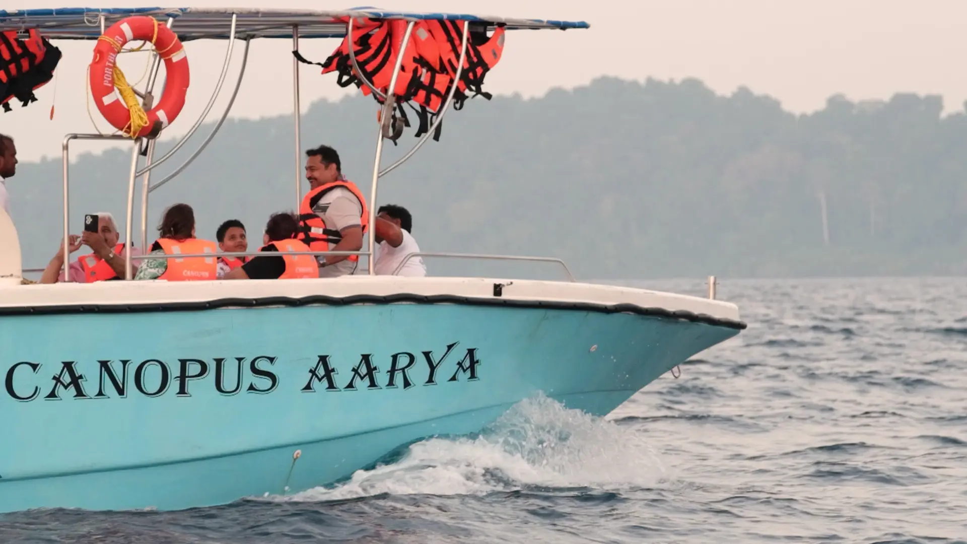 Guests in life jackets enjoying a ride on board Canopus Aarya